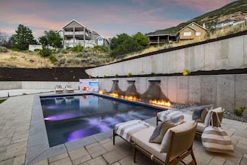 Landscaper-built outdoor living space with fireplace