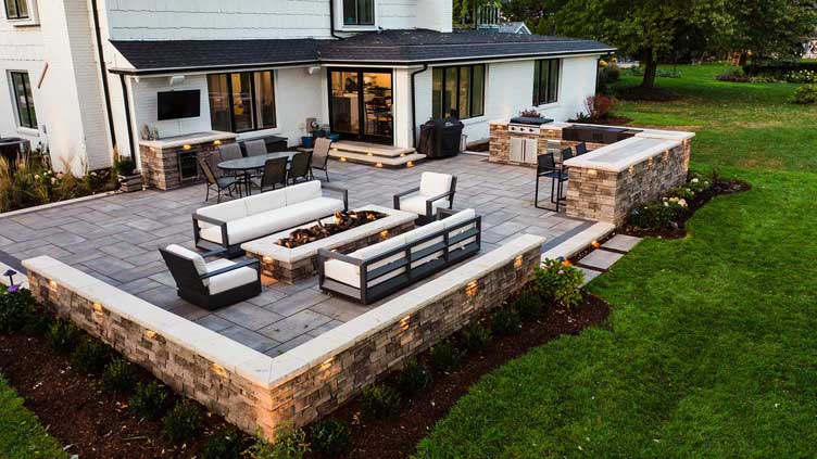 Covered patio with outdoor kitchen, fire pit, and dining area